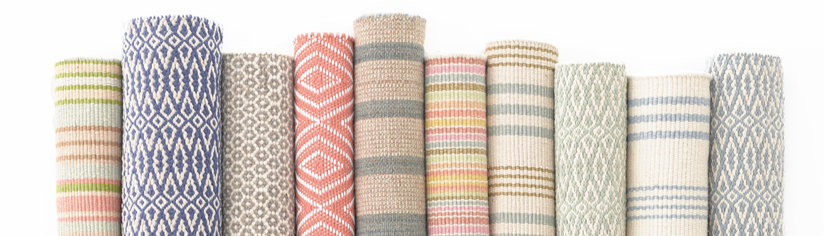 Rugs rolled up together